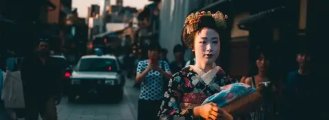 Geisha en kimono dans un jardin traditionnel à Kyoto, au Japon
